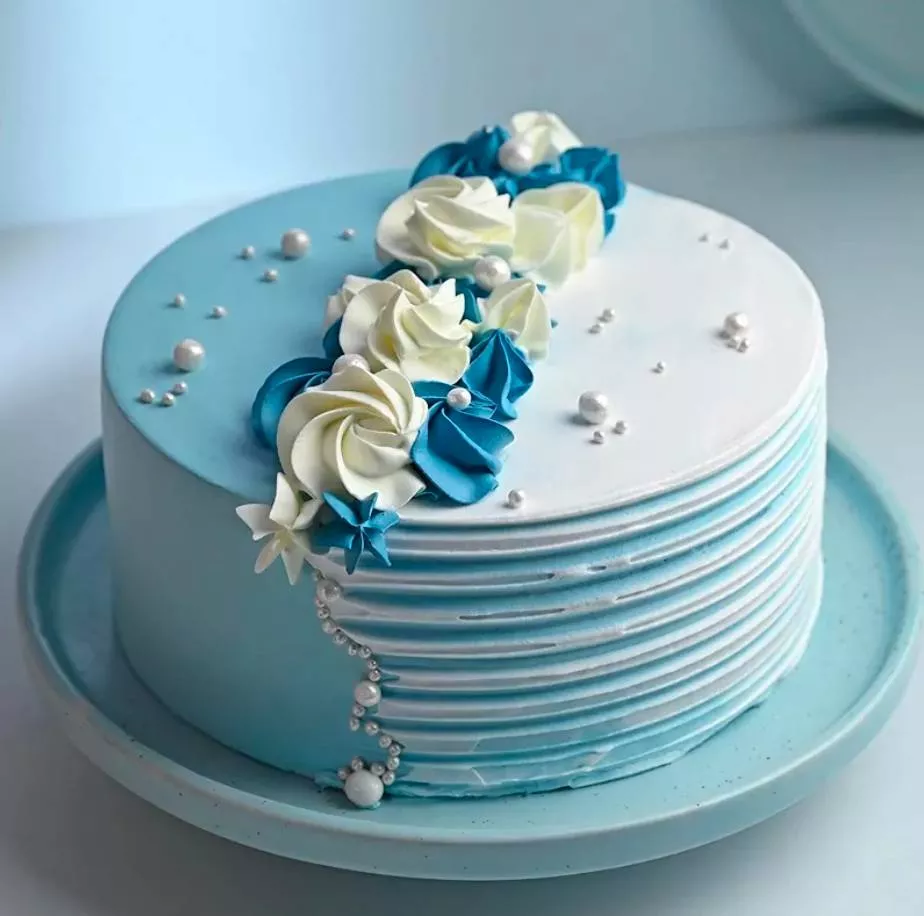 Elegant blue and white floral decorated cake from RAMA FRUITS MERCHANTS in KHAMMAM, perfect for special occasions, showcasing