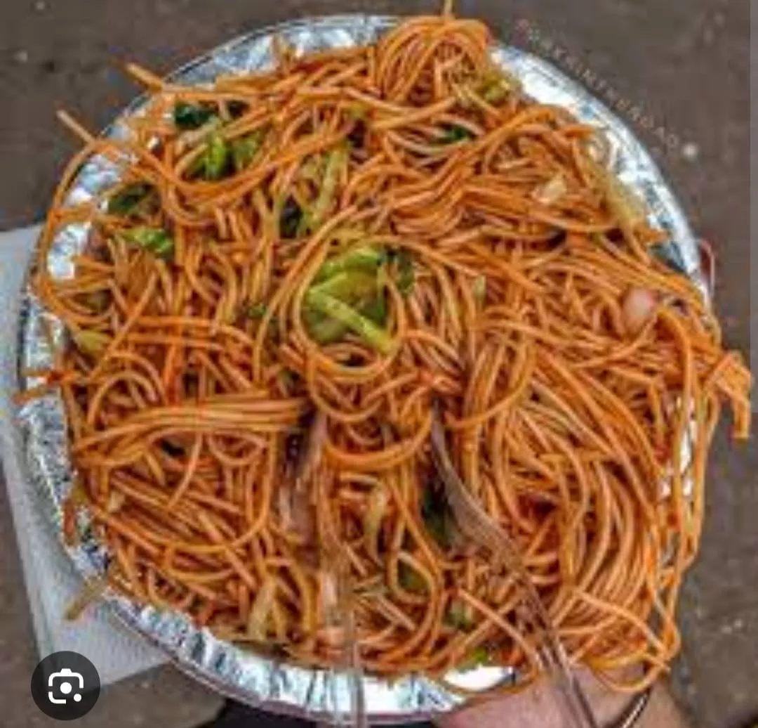 A serving of Veg Hakka Noodles featuring colorful fresh vegetables in Kullu, garnished and ready to eat.