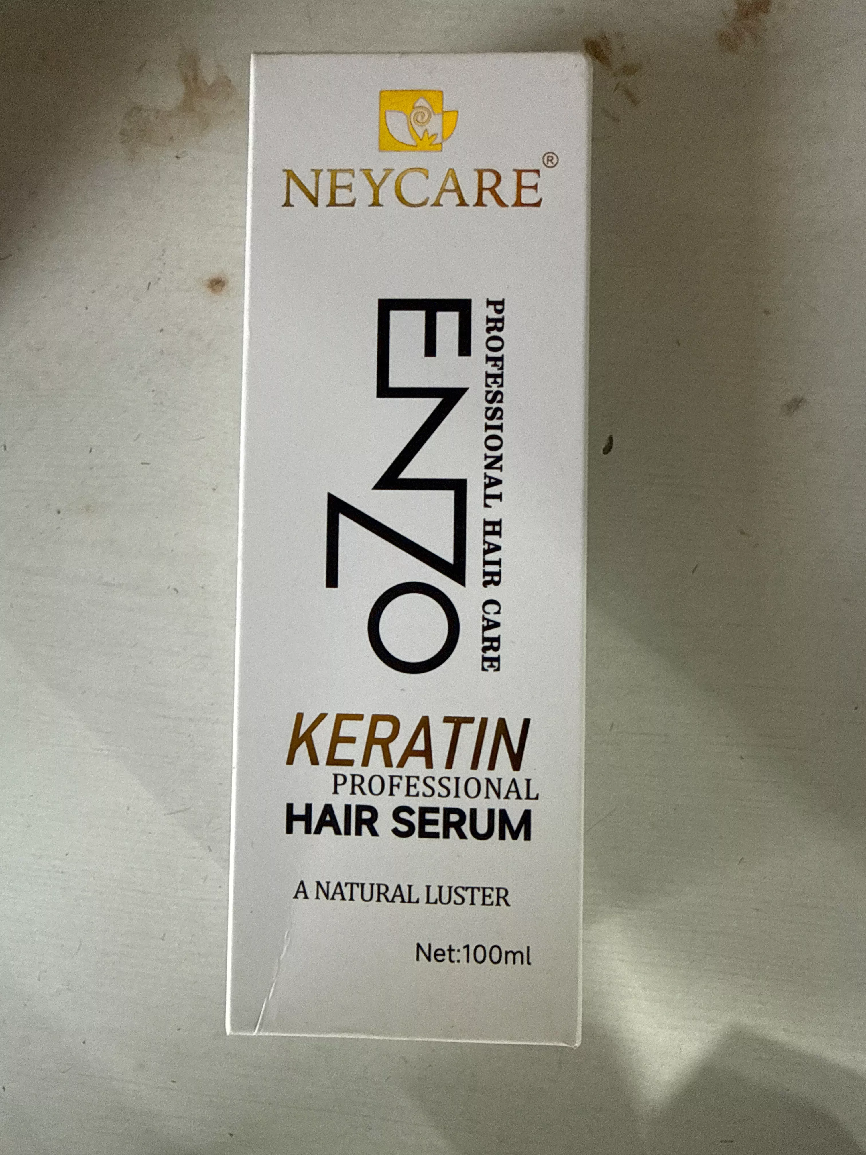 Neycare ENZO Keratin Professional Hair Serum in Kahnuwan with sleek packaging and a glossy finish, showcasing the product's p