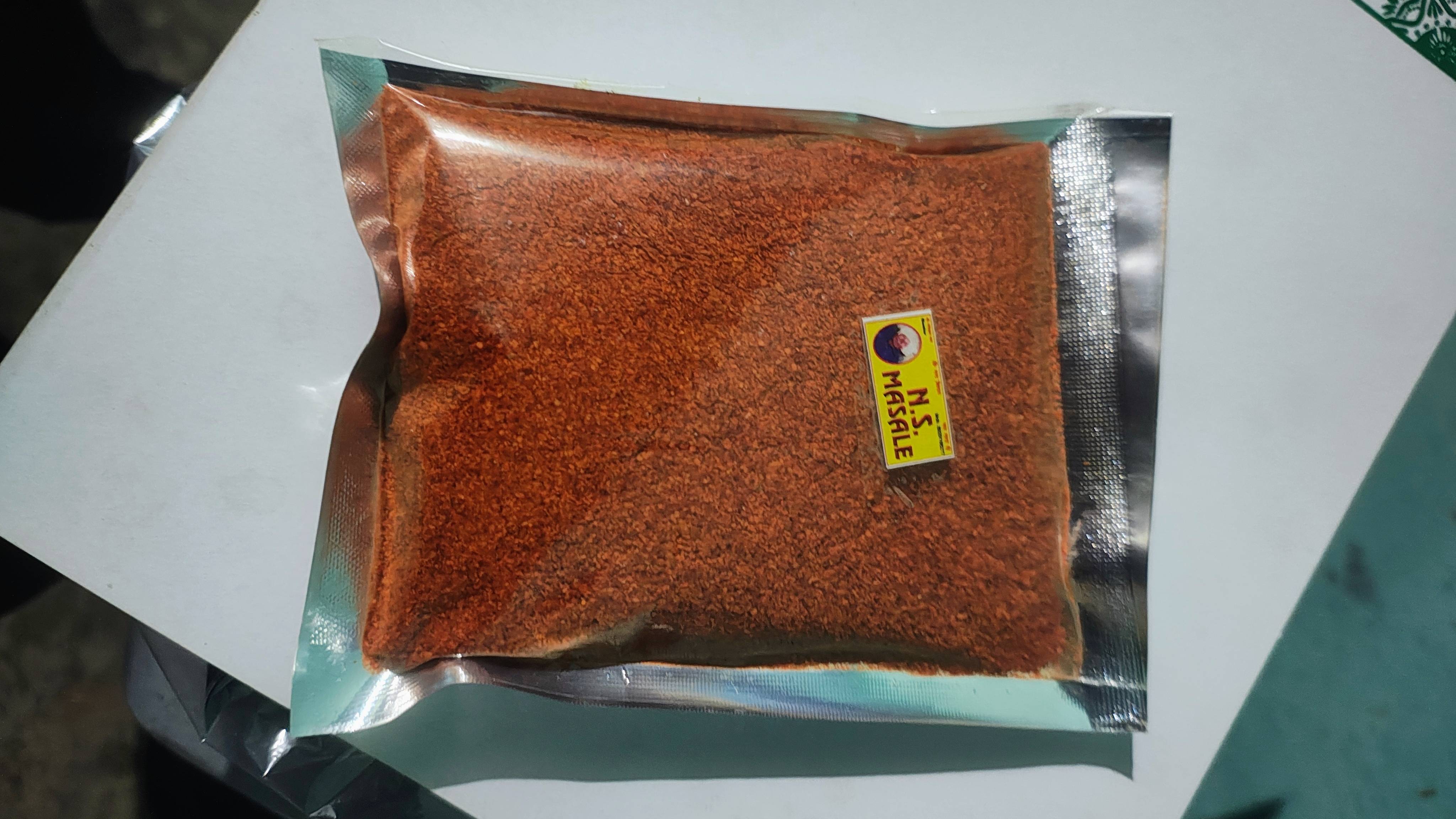 Finely ground red chilli powder in a bowl, vibrant red color, showcasing its spice quality and freshness, from SHANKAR in Son - Image 1