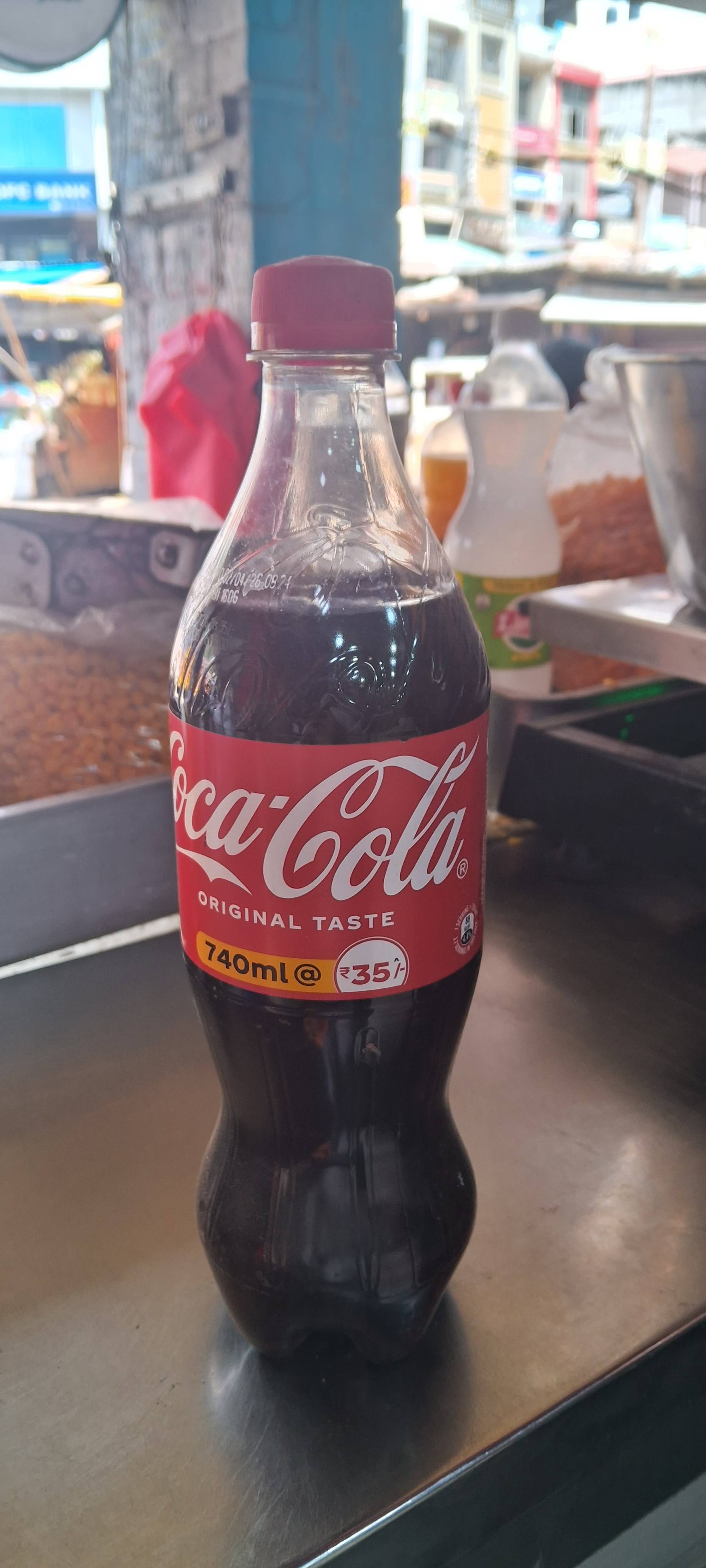 Coca Cola Beverage in Nadaun - refreshing carbonated drink with a classic taste, served in a chilled bottle
