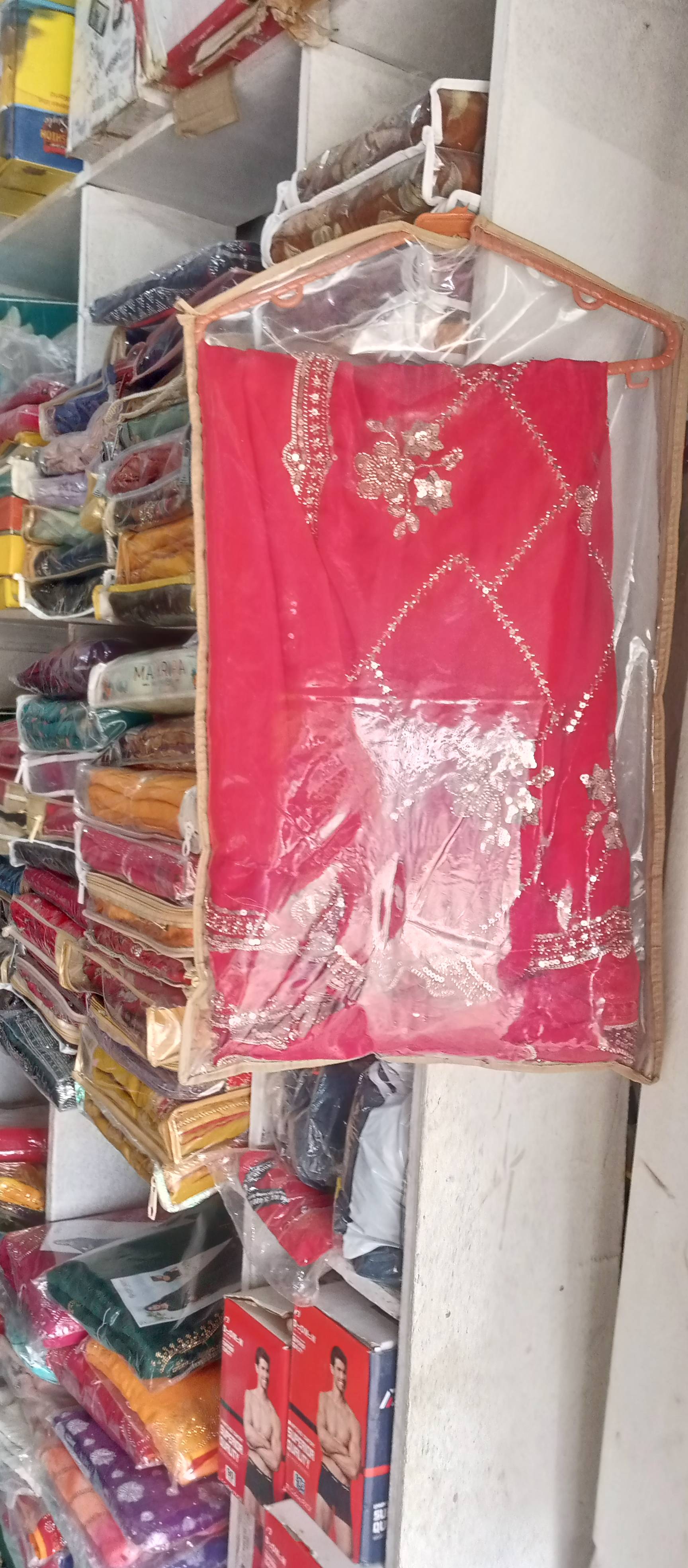 Embroidered Red Designer Saree featuring intricate designs and vibrant colors, showcasing Roli Garments in BABHANAN.