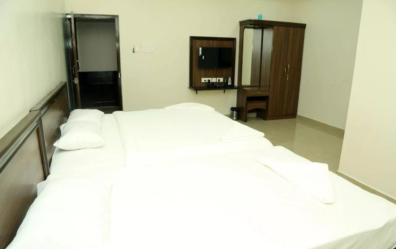 Spacious AC Family Room designed for 4 guests in Pallavaram, Chennai, featuring modern furnishings and cozy atmosphere.