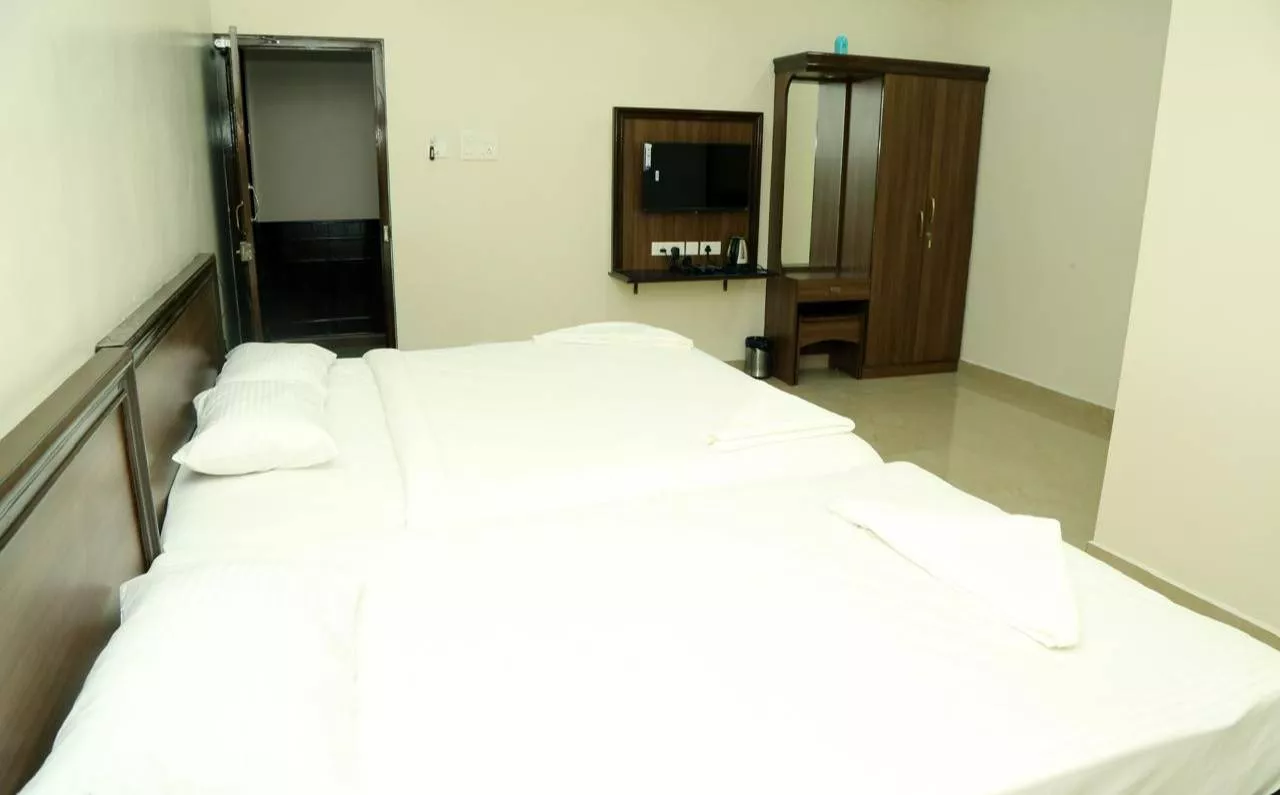 Comfortable AC Family Room accommodating 5 guests at SUDHA GRAND in Chennai, featuring modern decor and amenities.