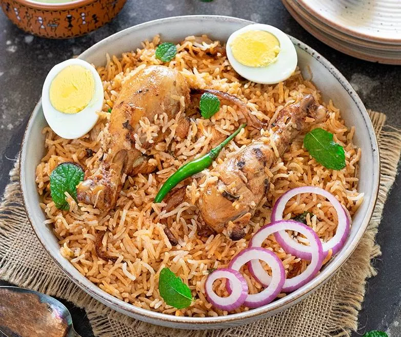 Delicious Biryani Mahal Biryani featuring fragrant basmati rice, succulent meat, and aromatic spices served in a bowl, freshl