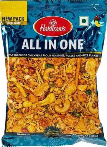 Haldiram's All In One Snack Mix featuring a mix of chickpeas flour noodles, pulses, and rice flakes in a colorful pack, avail