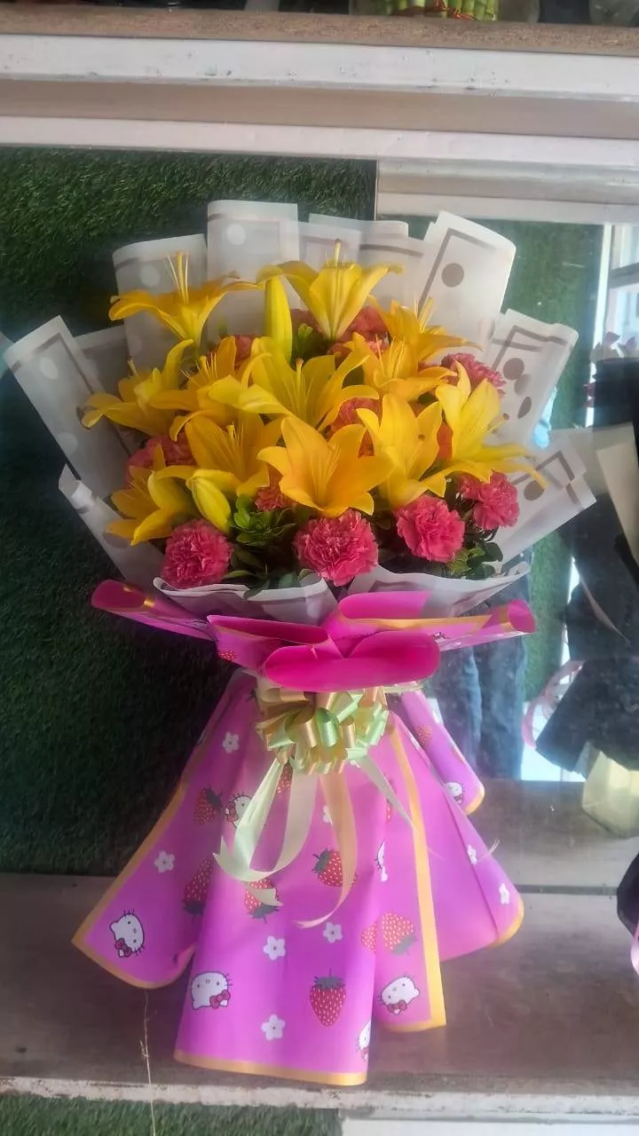 Brightly arranged vibrant lily and carnation bouquet in Noida featuring colorful blooms, perfect for celebrations.