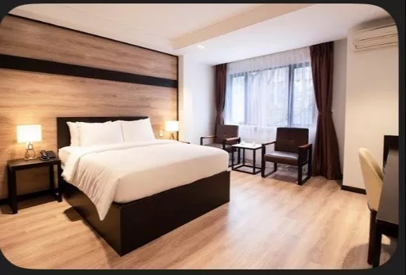 Stylish wooden room furniture set featuring a queen-sized bed, nightstands, and seating in Karbi Anglong