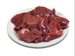 Fresh goat liver displayed on a wooden cutting board with herbs, showcasing its rich texture and color, available at WARIS CH