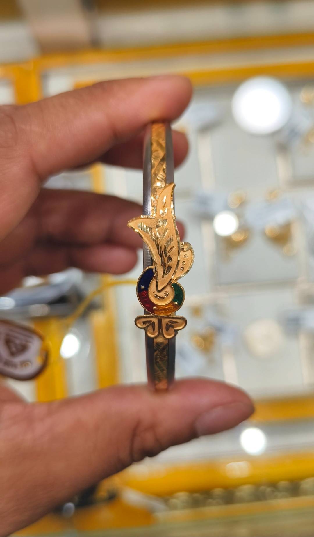 Elegant gold-plated Jewelry/Gold-capped Loha Badhano bangle with intricate detailing displayed in Twentyfour North Parganas.