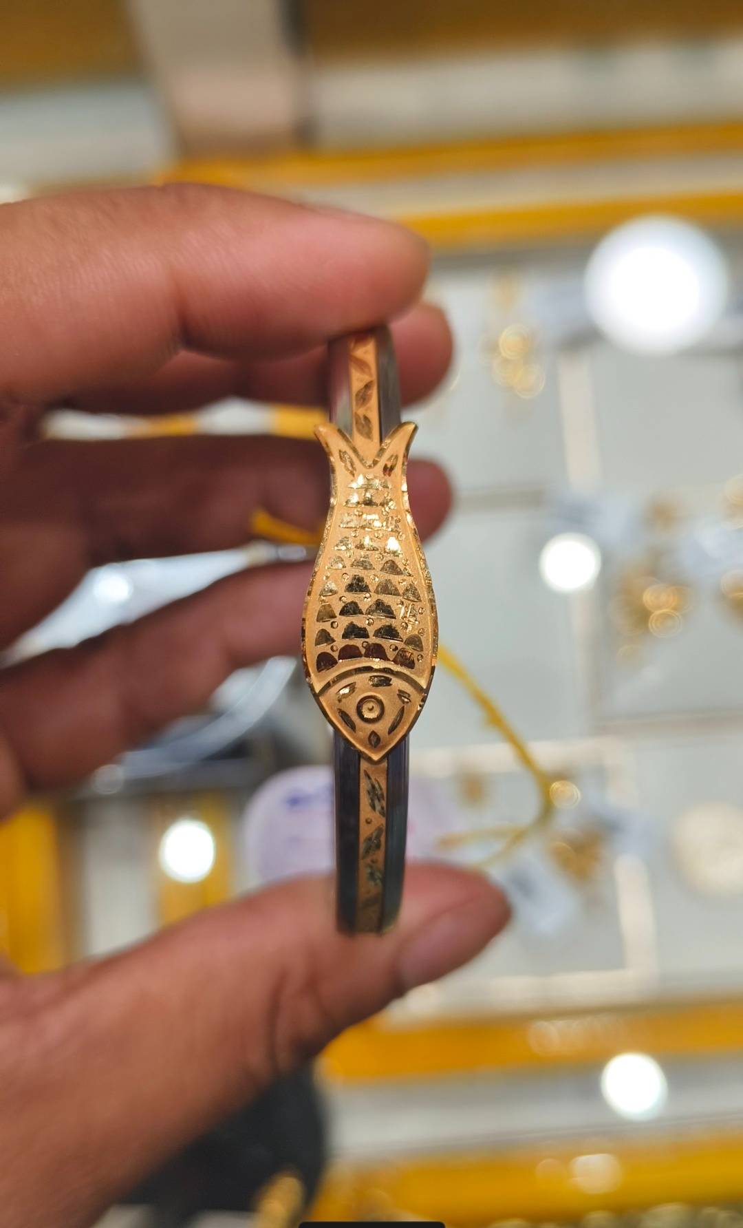 Elegant Jewelry/Gold-capped Loha Badhano with intricate designs, showcasing a blend of gold and durable material, available i