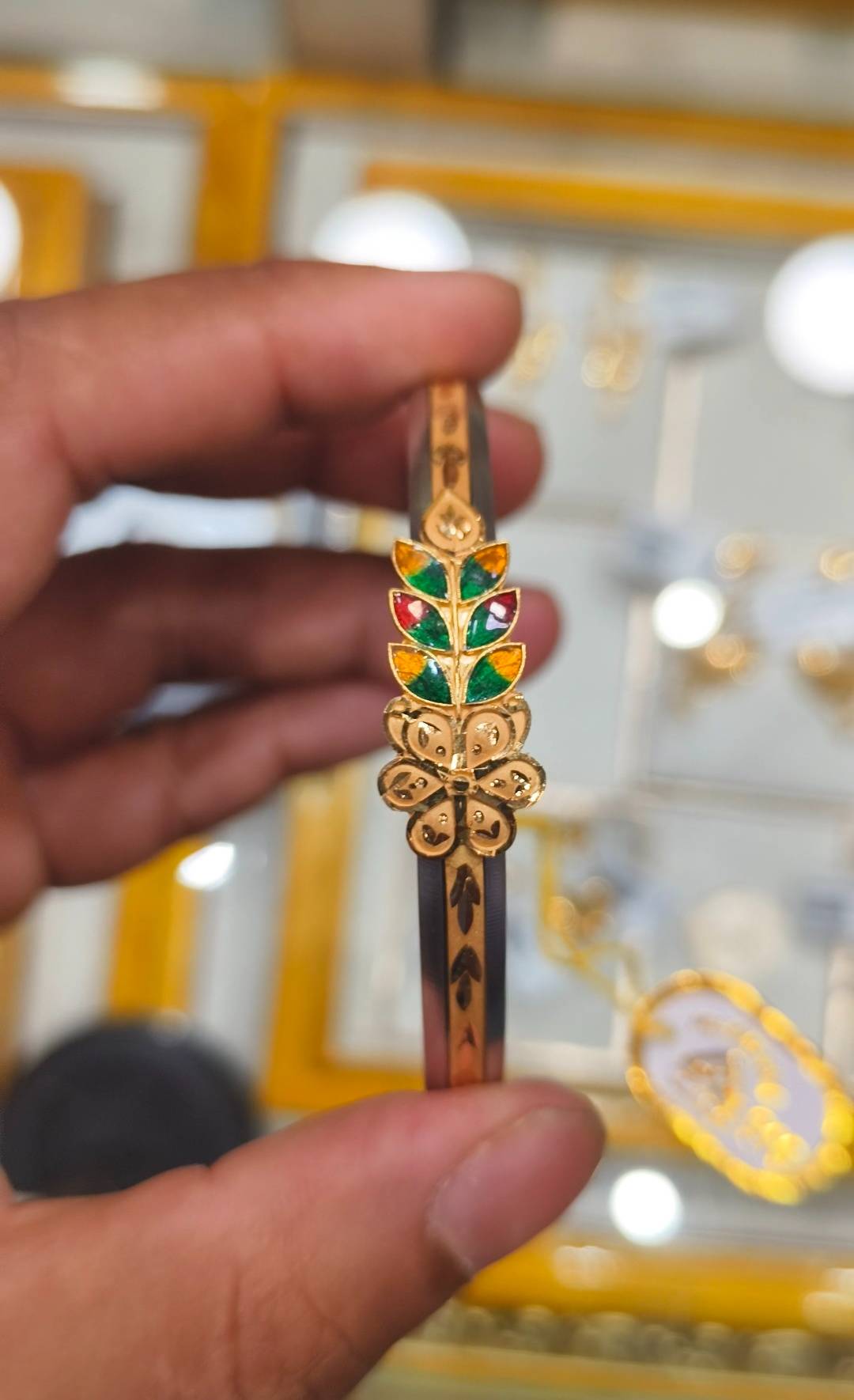 Handcrafted Jewelry/Gold-capped Loha Badhano kada featuring multicolor enamel detailing, available at SHIV GOURI JEWELLERS in