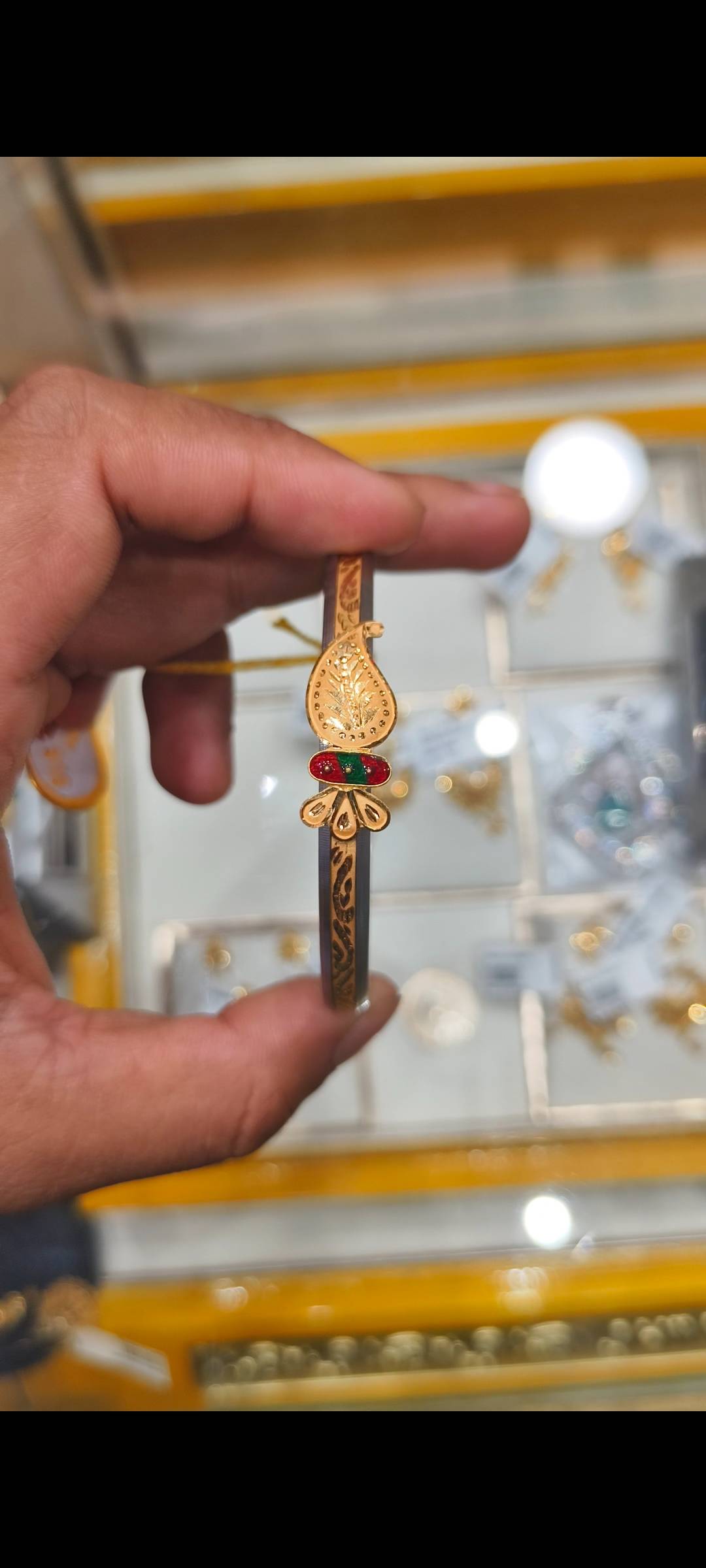Elegant gold-plated Jewelry/Gold-capped Loha Badhano bangle with intricate detailing displayed in Twentyfour North Parganas.