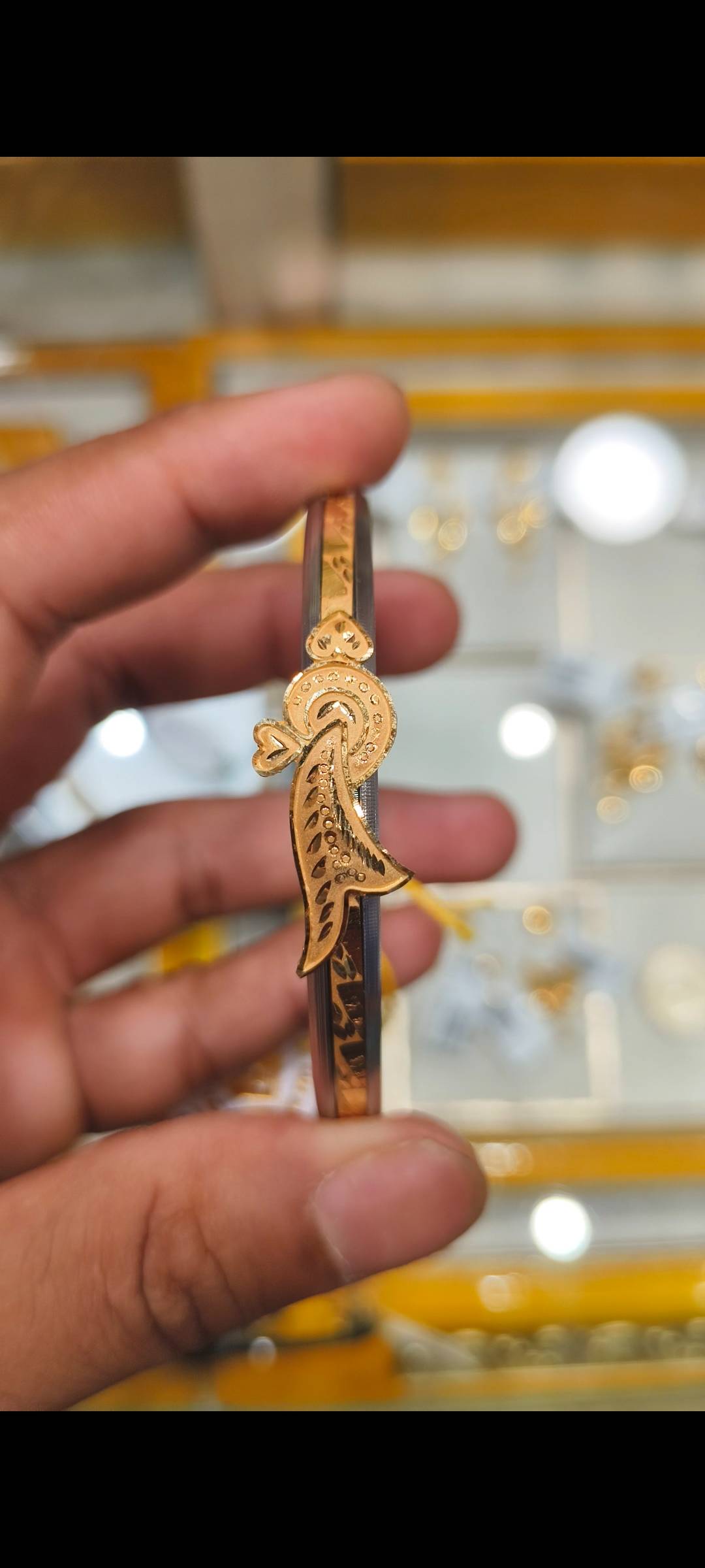 Elegant Jewelry/Gold-capped Loha Badhano featuring intricate designs and a luxurious gold finish, available at SHIV GOURI JEW