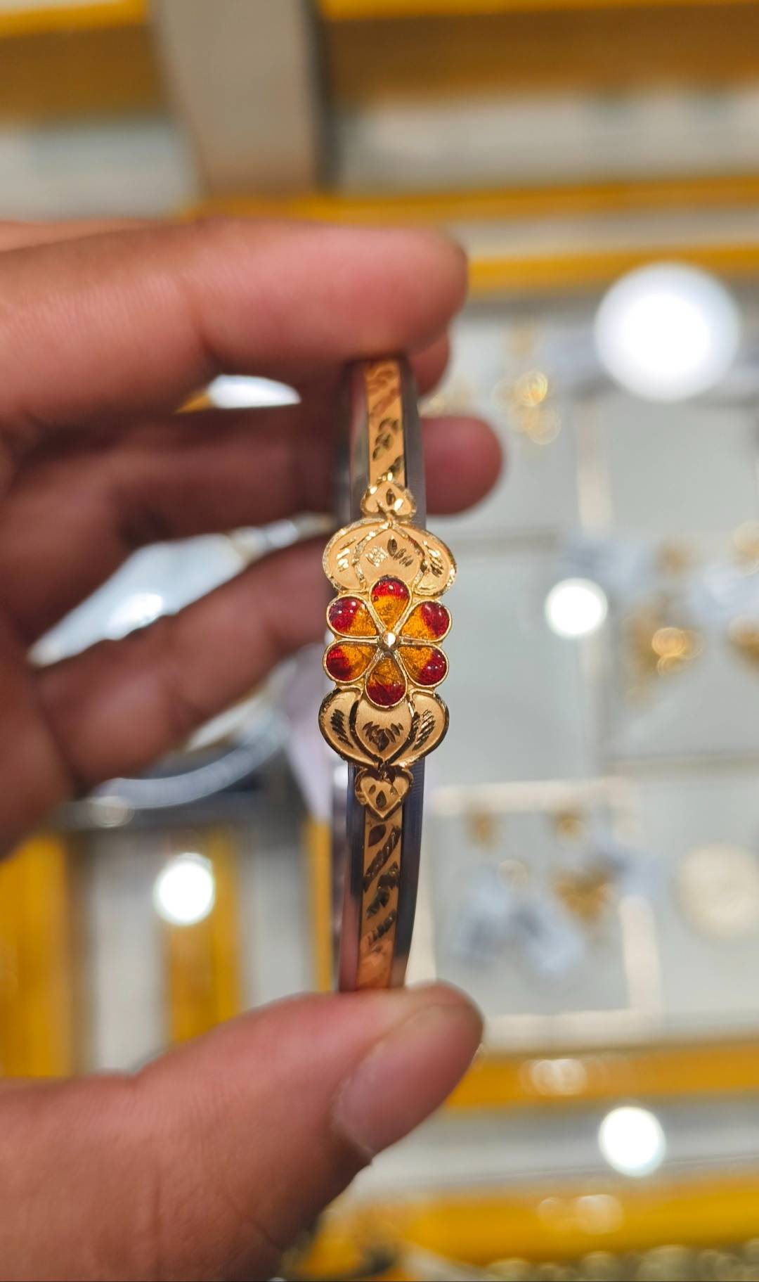Elegant Jewelry/Gold-capped Loha Badhano with intricate designs, showcasing a blend of gold and durable material, available i
