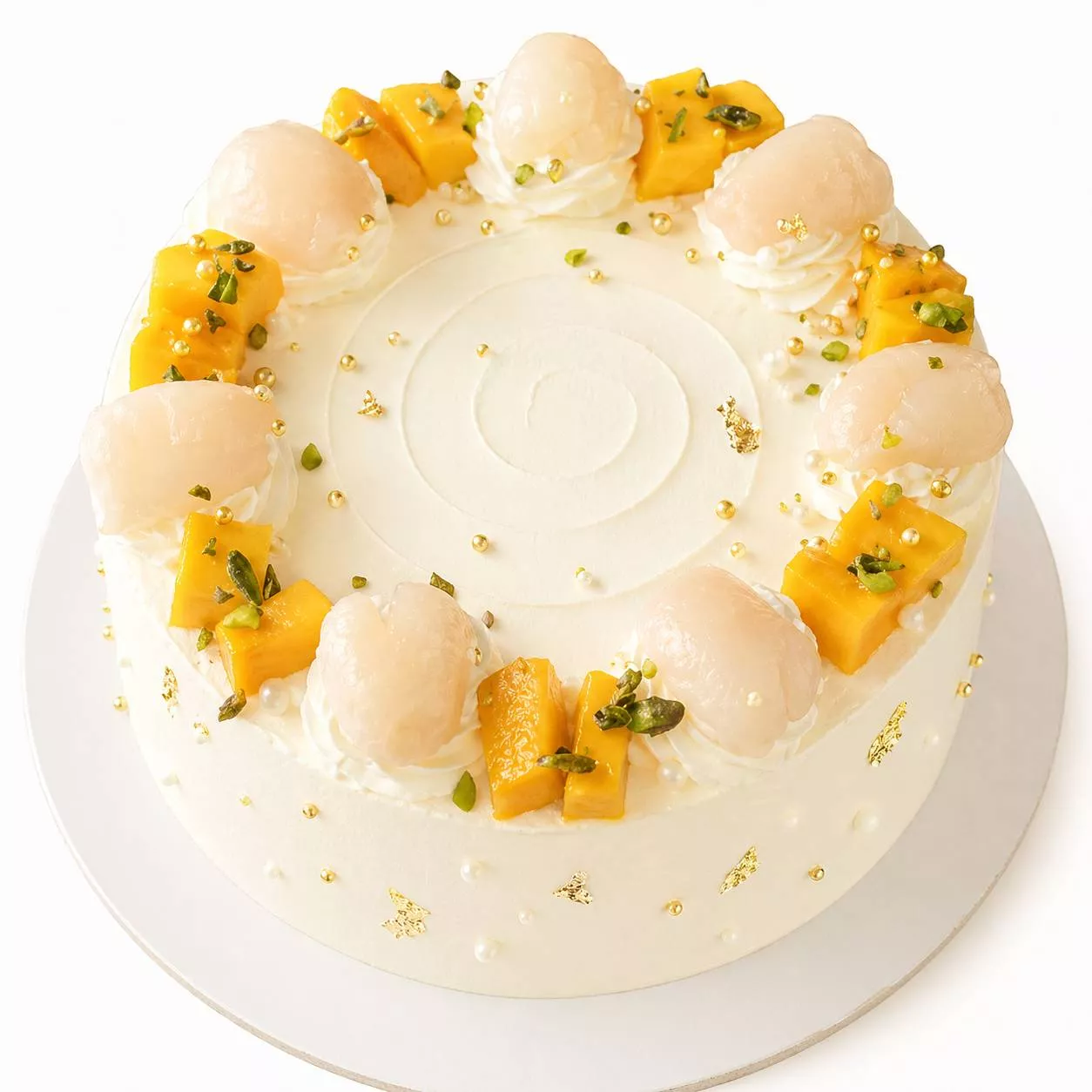 Luxurious Exotic Fruit Celebration Cake with vibrant lychees, mangoes, and pistachios, beautifully presented for celebrations