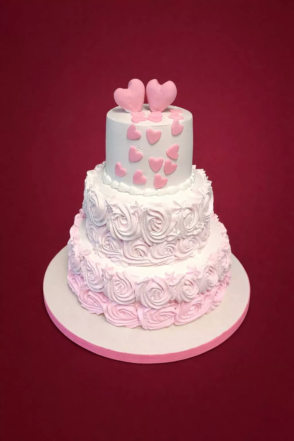 Three-tiered Romantic Hearts Cake with pink and white heart decorations in Bangalore — a perfect centerpiece for celebrations