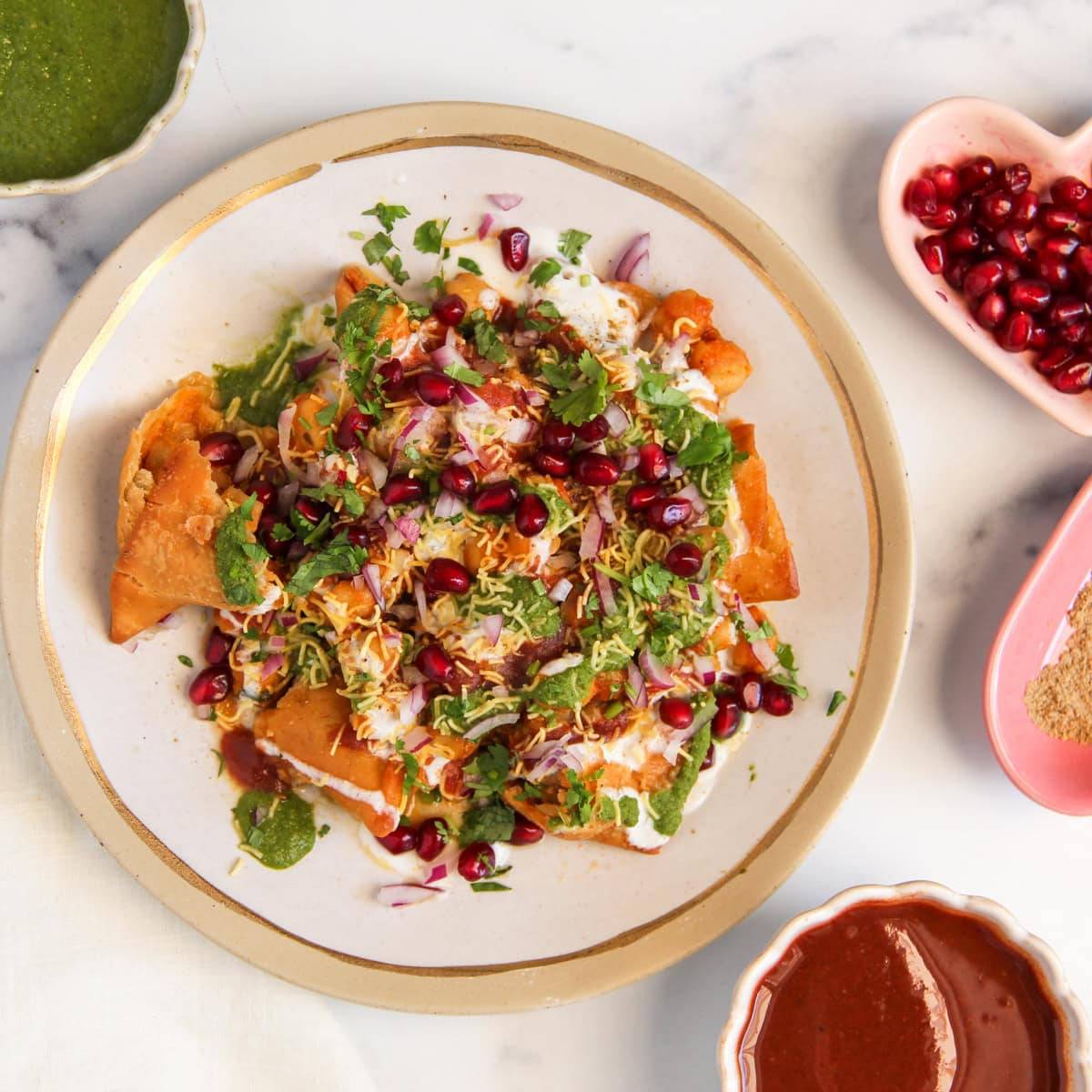 Crispy Samosha Chaat topped with unique spices and garnishes, beautifully plated in CHICPAWAN.