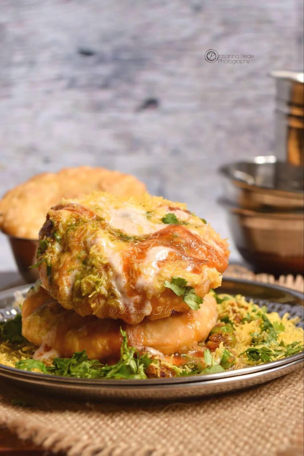 Crispy Kachori Chaat topped with colorful chutneys and spices from PARTEEK SWEETS AND RESTAURANTS in CHICPAWAN, showcasing a 