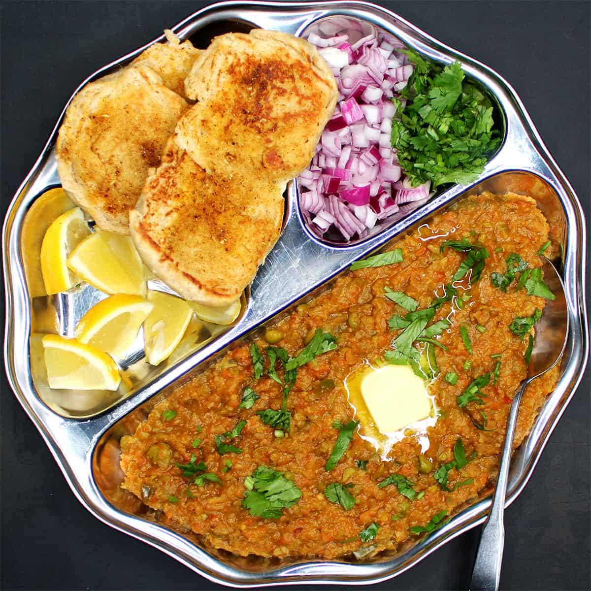 Delicious Pav Bhaji served with soft buttered bread at PARTEEK SWEETS AND RESTAURANTS in Chicpawan, showcasing rich colors an