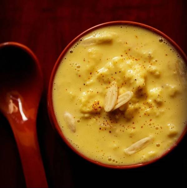 Rich and creamy Rabdi Dessert in Parthek from PARTEEK SWEETS AND RESTAURANTS, Chicpawan, served in a traditional bowl with a 
