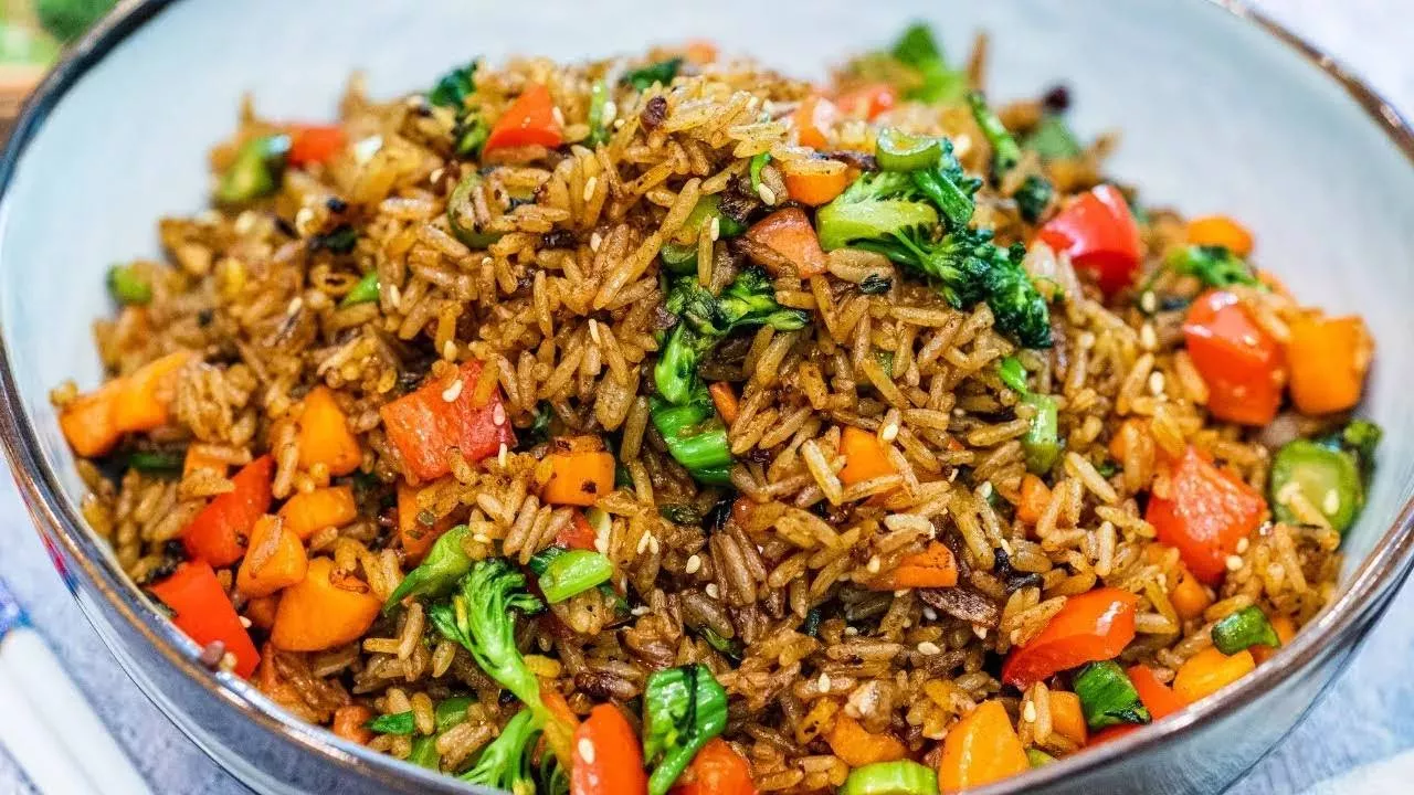 Delicious Veg Fried Rice with colorful vegetables served in a bowl at PARTEEK SWEETS AND RESTAURANTS in CHICPAWAN.