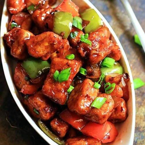 Delicious Chilli Paneer served hot, featuring vibrant colors and a spicy sauce, from PARTEEK SWEETS AND RESTAURANTS in CHICPA
