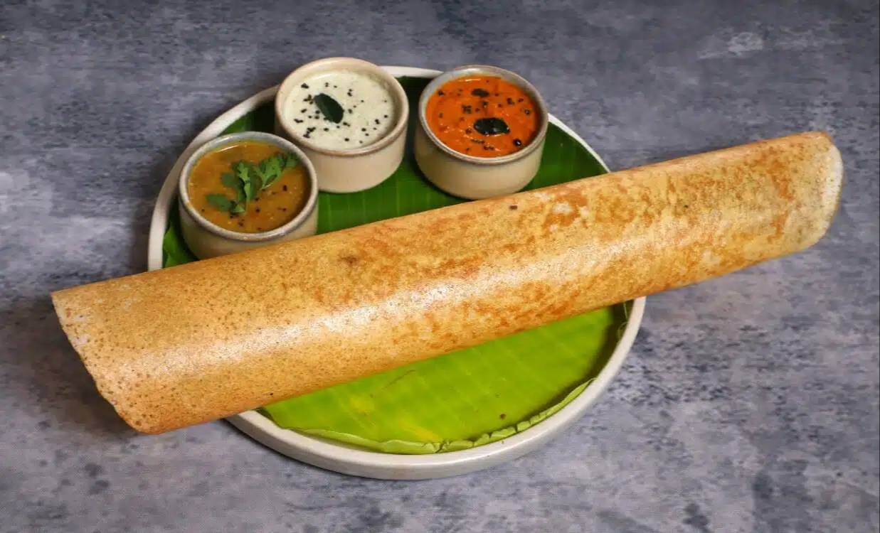 Delicious Plain Masala Dosa served on a plate with chutney, from PARTEEK SWEETS AND RESTAURANTS in Chicpawan, showcasing its 