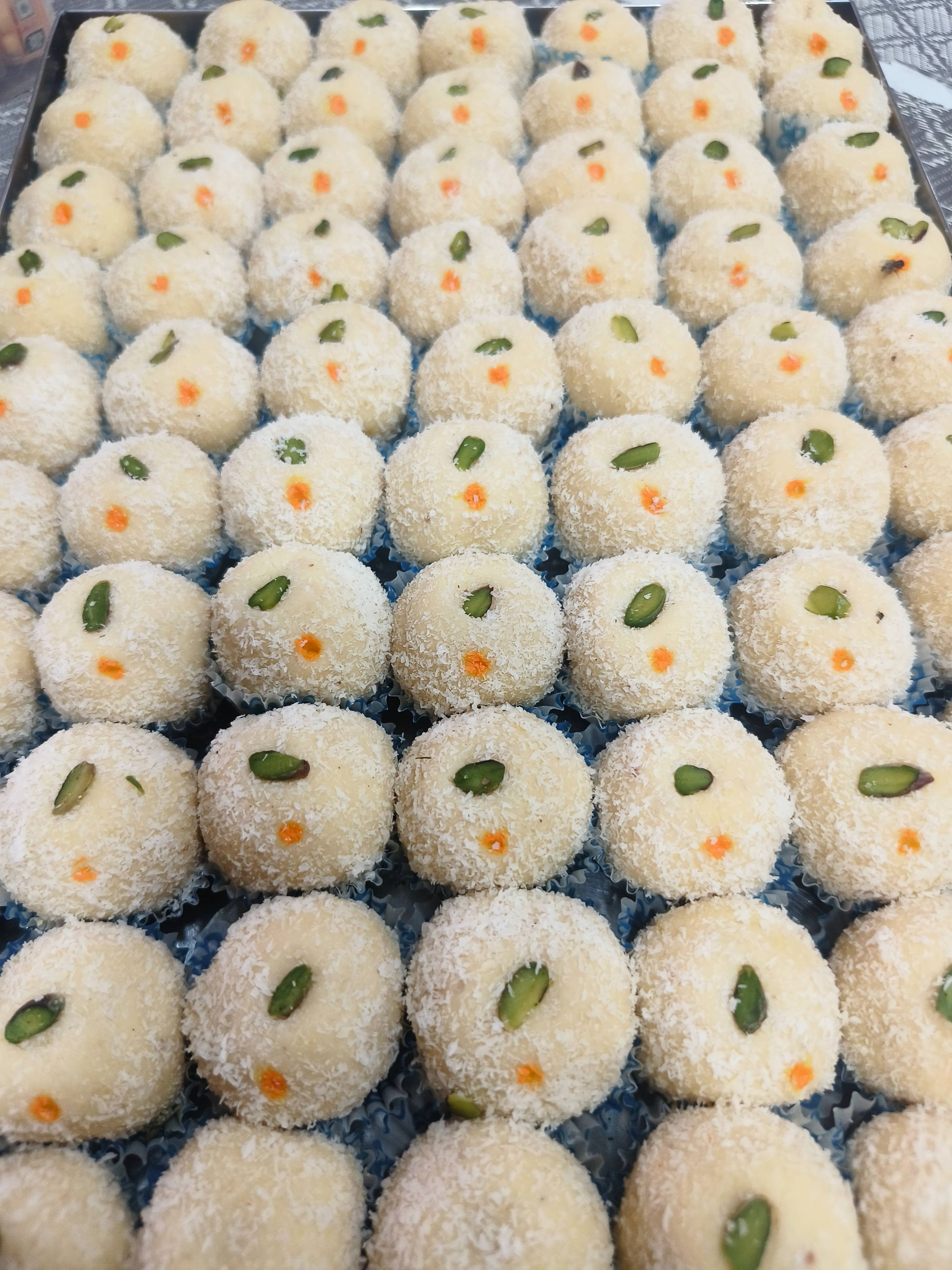 Delicious Coconut Ladoo with pistachio garnish from PARTEEK SWEETS AND RESTAURANT in Chicpawan, showcasing its soft texture a