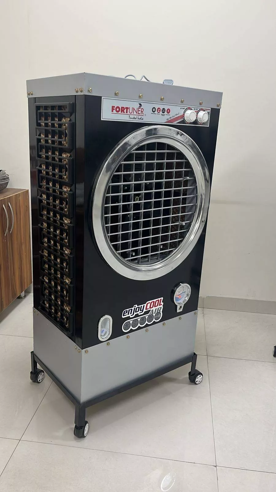 Fortuner Enjoy Cool Air Cooler showcasing its modern design and controls, ideal for cooling indoor spaces, available in Sangr