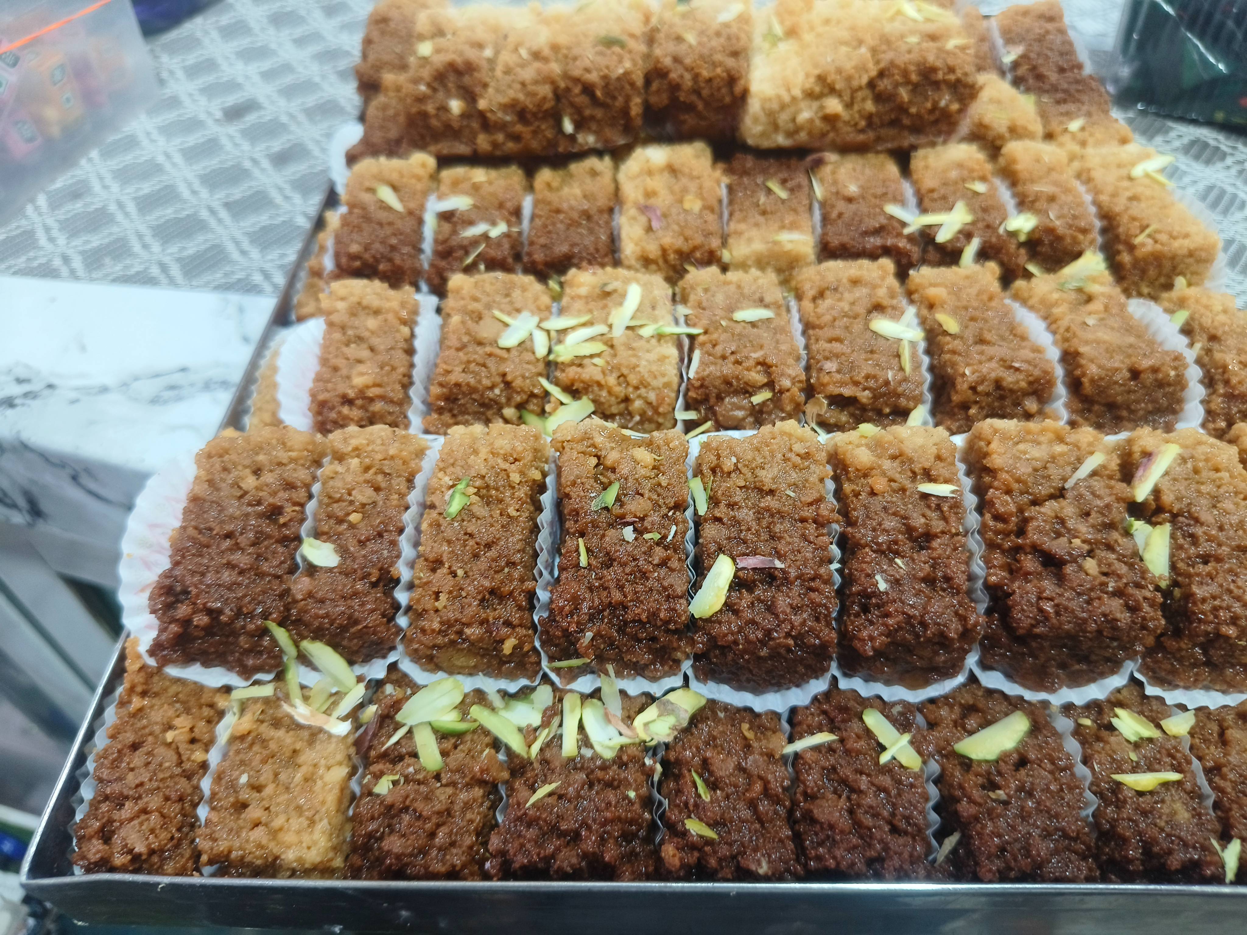 Delicious Special Desi Ghee Milk Cake in Chicpawan, showcasing a rich and crumbly texture with a golden hue.