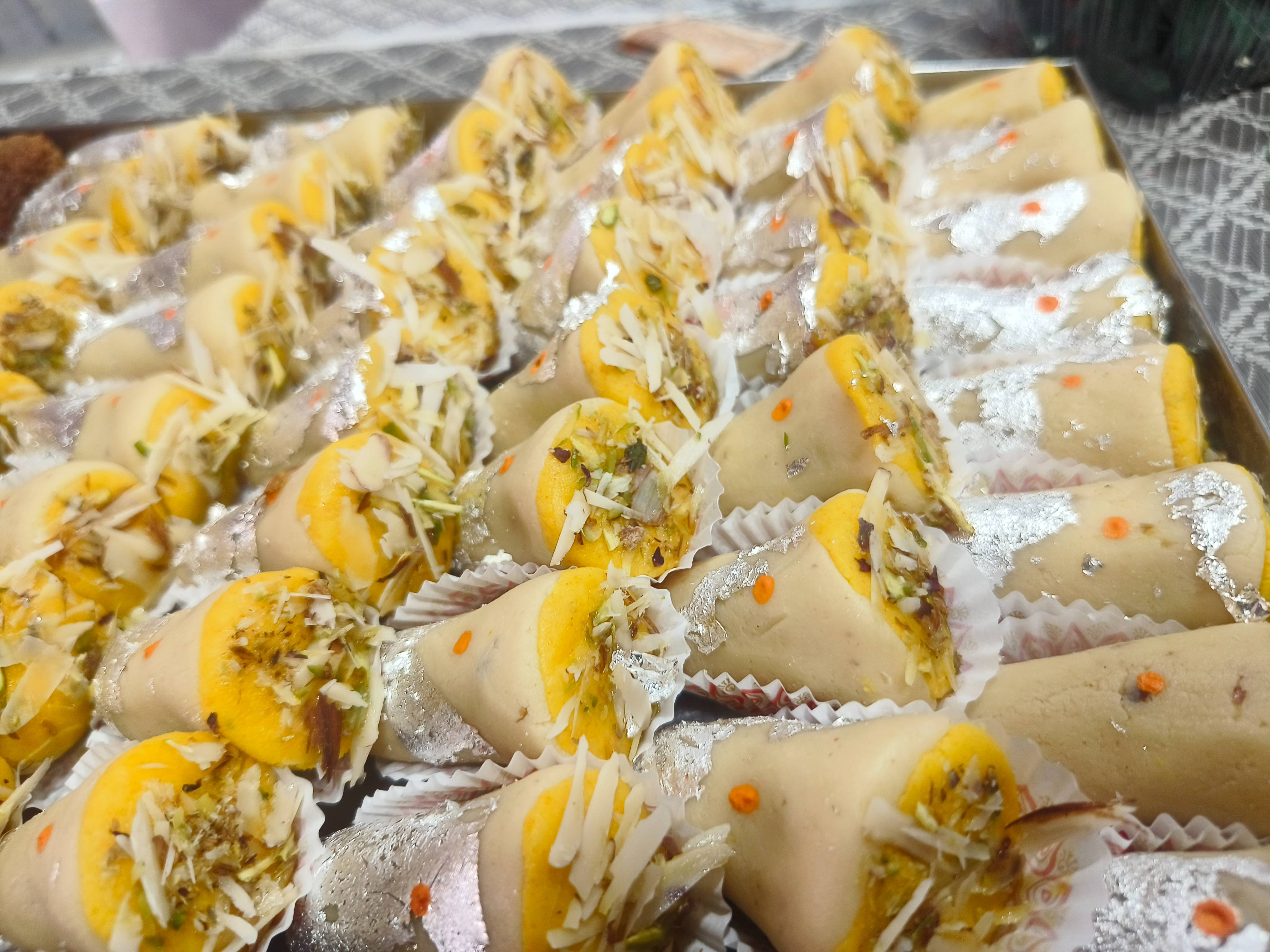 Luxurious PARTY SWEETS Mawa Cone featuring rich cashew rolls filled with pistachio, served in Chicpawan.