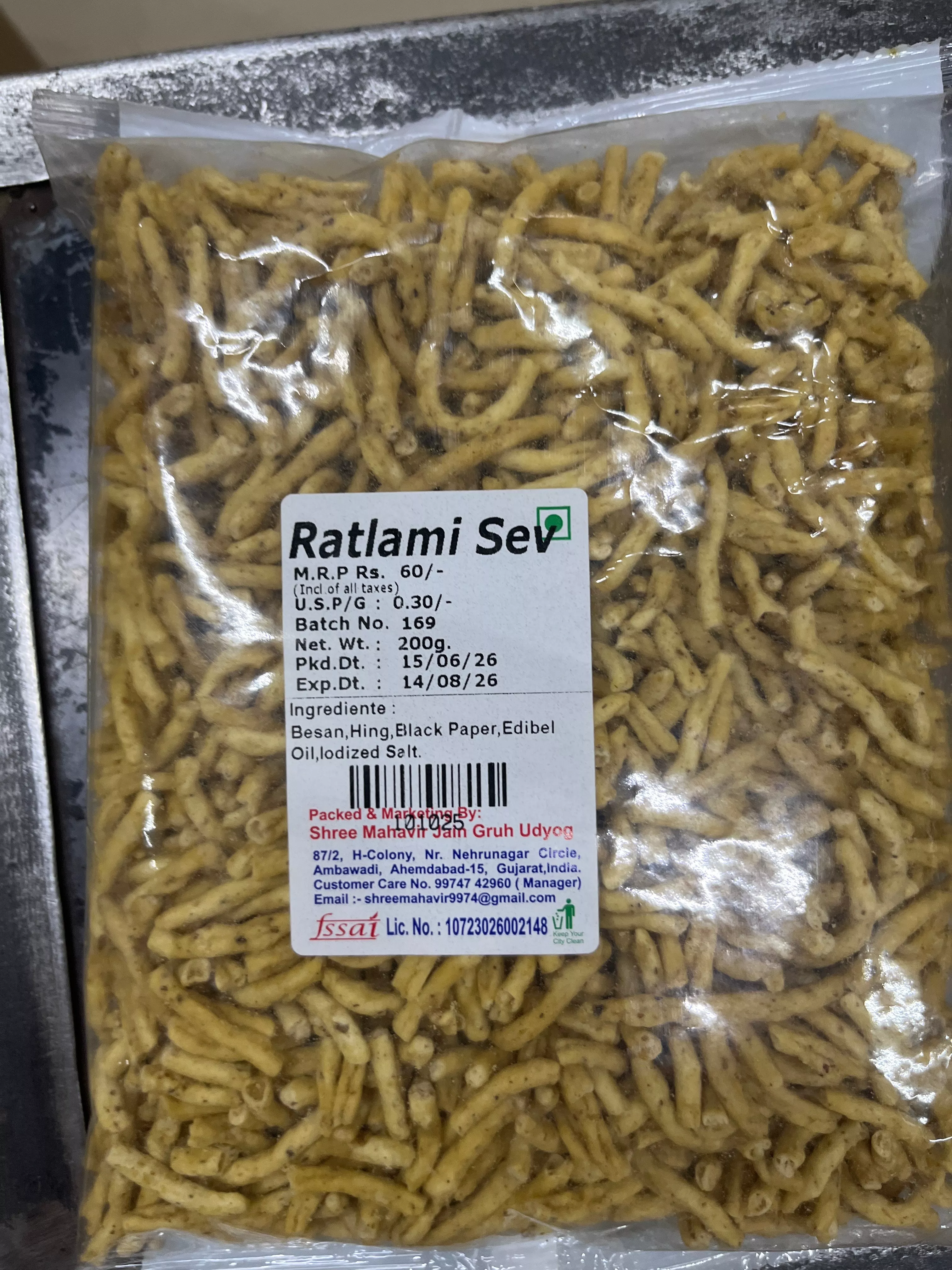 Crispy RATLAMI SEV snack pack displayed with Ahmedabad backdrop